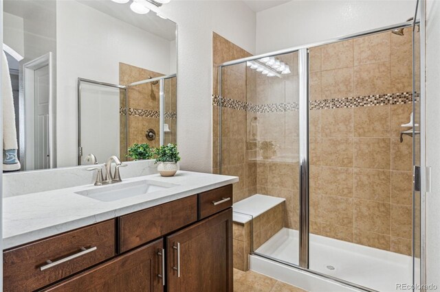 bathroom featuring vanity and an enclosed shower