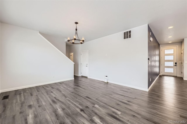 interior space with visible vents, baseboards, dark wood finished floors, and a chandelier