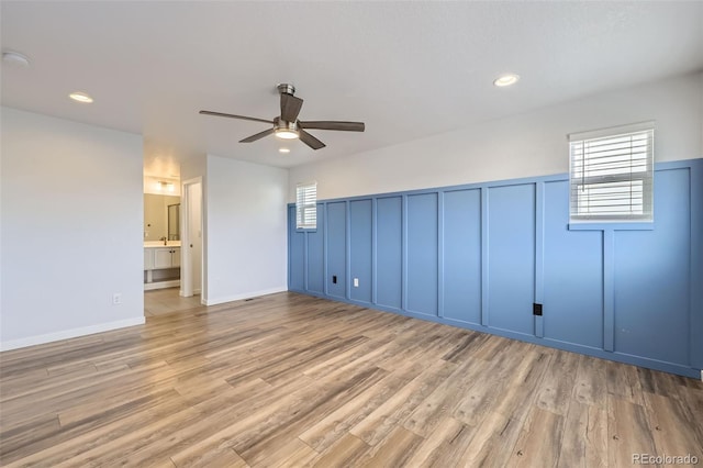 spare room featuring a decorative wall, recessed lighting, ceiling fan, and wood finished floors