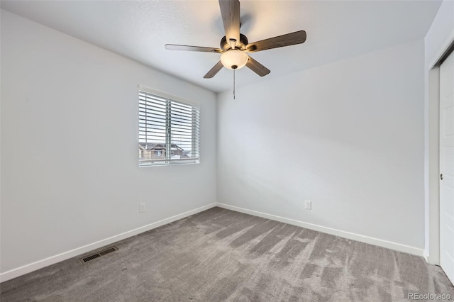 unfurnished room with visible vents, carpet flooring, a ceiling fan, and baseboards