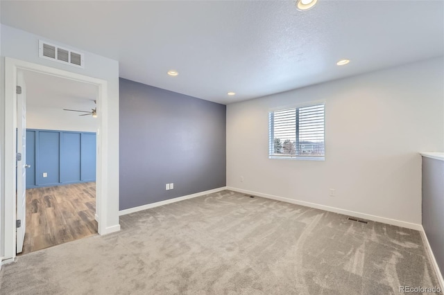 empty room featuring recessed lighting, carpet, visible vents, and baseboards