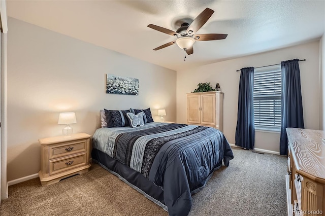 carpeted bedroom with baseboards and a ceiling fan