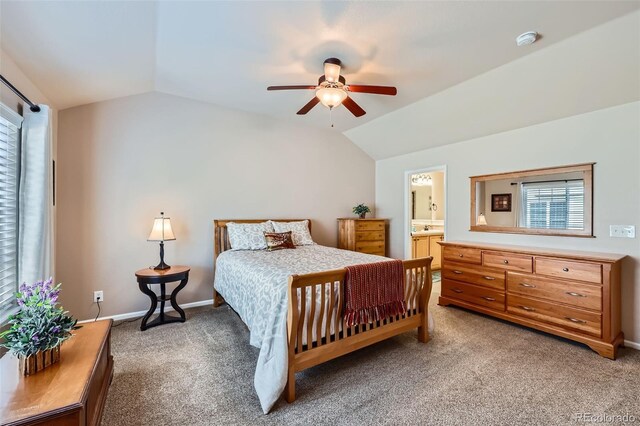 bedroom featuring light carpet, a sink, multiple windows, and lofted ceiling