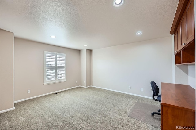 unfurnished office with recessed lighting, a textured ceiling, and carpet floors