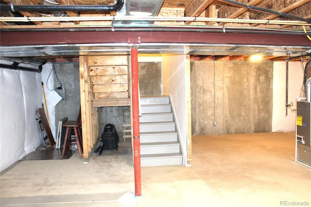 unfinished below grade area featuring stairs