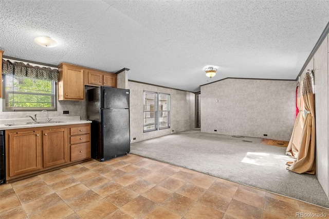 715 E Chester St, Lafayette, CO 80026 - kitchen featuring freestanding refrigerator, a textured ceiling, light countertops, open floor plan, and brown cabinets