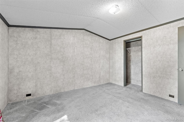 715 E Chester St, Lafayette, CO 80026 - unfurnished bedroom with carpet, vaulted ceiling, ornamental molding, a textured ceiling, and a closet