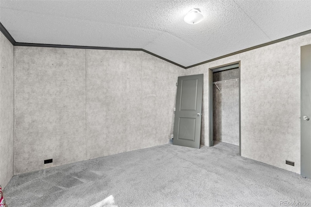 715 E Chester St, Lafayette, CO 80026 - unfurnished bedroom with vaulted ceiling, carpet, ornamental molding, a closet, and a textured ceiling