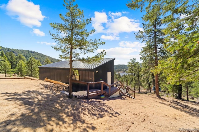 161 Highland Cir, Rye, CO 81069 - rear view of property with a wooded view and metal roof