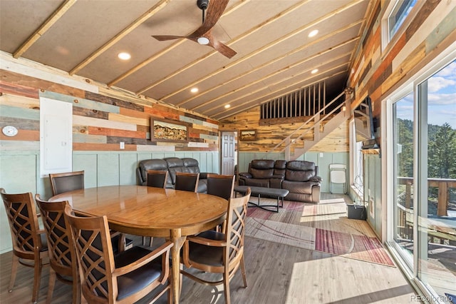 161 Highland Cir, Rye, CO 81069 - dining area featuring stairs, vaulted ceiling, wood finished floors, wooden walls, and ceiling fan