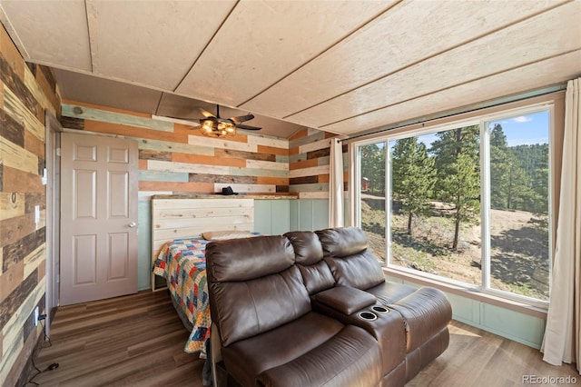 161 Highland Cir, Rye, CO 81069 - bedroom featuring wooden walls, multiple windows, and wood finished floors