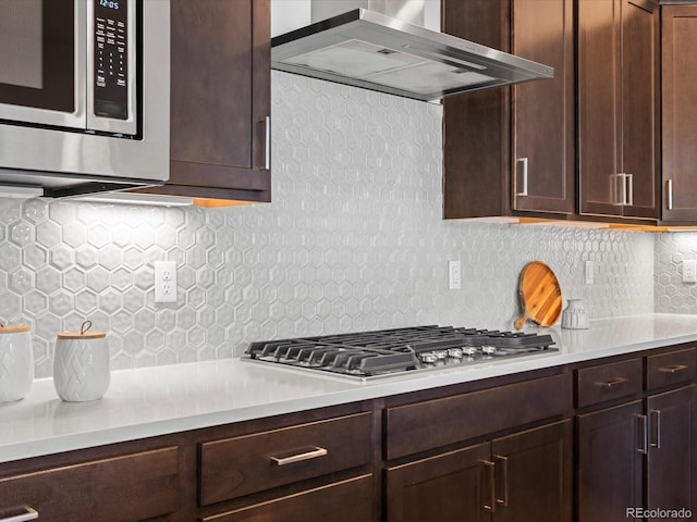 10235 E 59th Ave, Denver, CO 80238 - kitchen with wall chimney exhaust hood, stainless steel appliances, tasteful backsplash, and light countertops