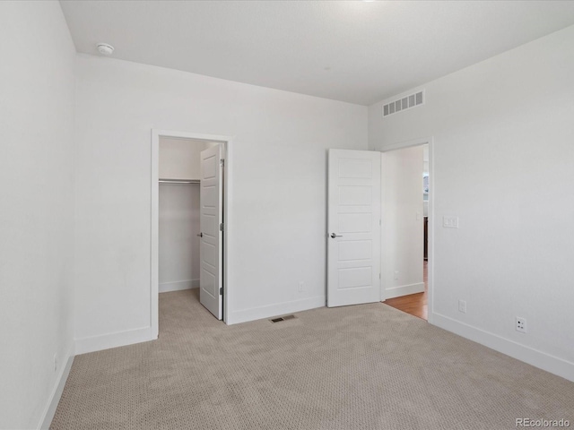 10235 E 59th Ave, Denver, CO 80238 - unfurnished bedroom featuring carpet flooring and a walk in closet