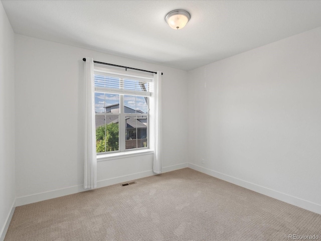 10235 E 59th Ave, Denver, CO 80238 - spare room featuring light carpet and baseboards