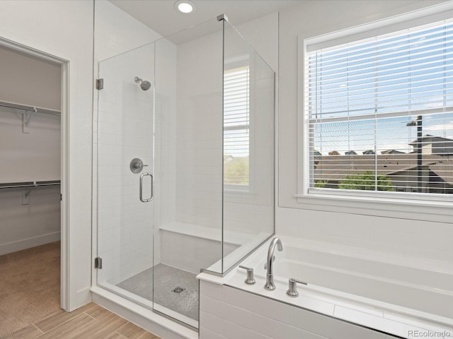 10235 E 59th Ave, Denver, CO 80238 - bathroom featuring a stall shower, a garden tub, a spacious closet, wood finished floors, and recessed lighting