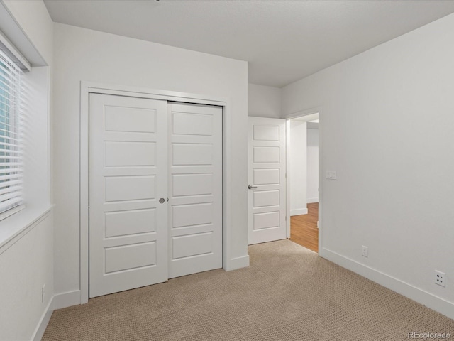 10235 E 59th Ave, Denver, CO 80238 - unfurnished bedroom with carpet flooring and a closet