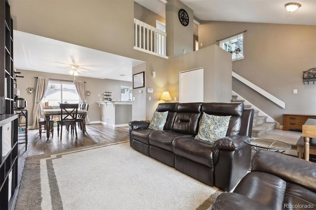 21125 E 43rd Ave, Denver, CO 80249 - living area featuring wood finished floors, stairway, a ceiling fan, lofted ceiling, and baseboards