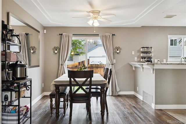 21125 E 43rd Ave, Denver, CO 80249 - dining space with ceiling fan, dark wood-style flooring, baseboards, and a raised ceiling