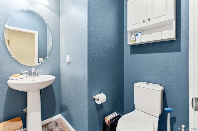 7018 E 123rd Pl, Thornton, CO 80602 - bathroom with toilet and wood finished floors