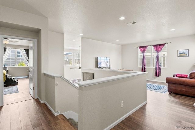 7018 E 123rd Pl, Thornton, CO 80602 - hall featuring wood-type flooring, an upstairs landing, baseboards, and recessed lighting