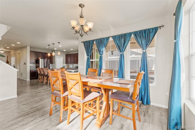 7018 E 123rd Pl, Thornton, CO 80602 - dining space with a chandelier, baseboards, light wood-type flooring, and recessed lighting