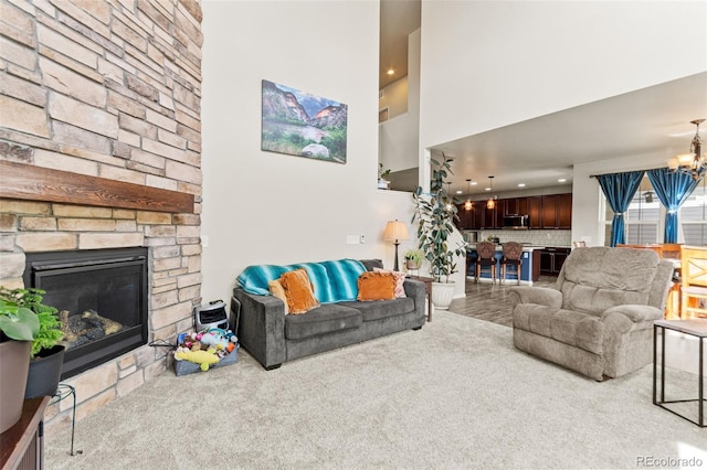 7018 E 123rd Pl, Thornton, CO 80602 - living room with a chandelier, a towering ceiling, a fireplace, and carpet