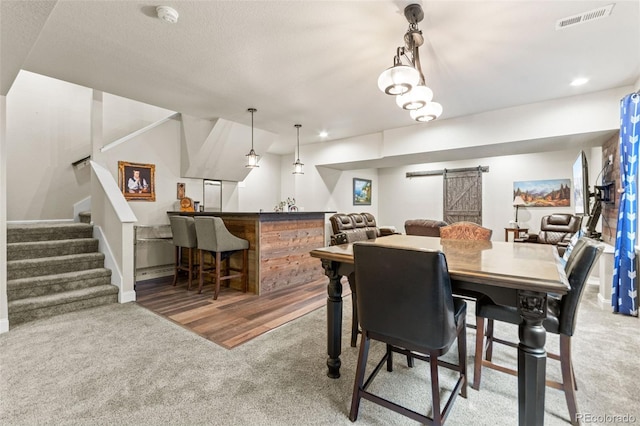 7018 E 123rd Pl, Thornton, CO 80602 - carpeted dining area featuring a barn door, a bar, stairway, and baseboards