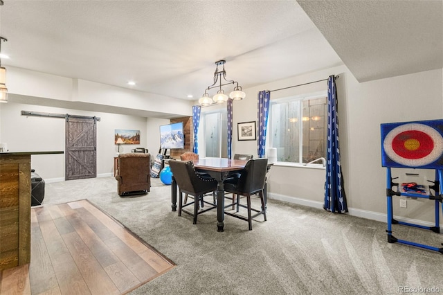 7018 E 123rd Pl, Thornton, CO 80602 - carpeted dining room featuring a barn door, baseboards, a textured ceiling, and recessed lighting