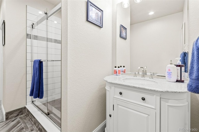 7018 E 123rd Pl, Thornton, CO 80602 - bathroom featuring a stall shower, vanity, and a textured wall