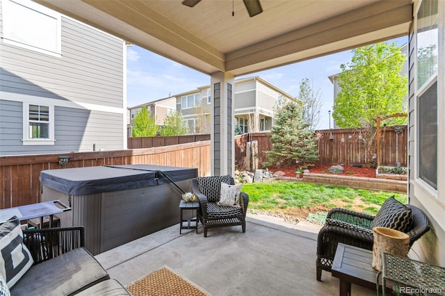 7018 E 123rd Pl, Thornton, CO 80602 - fenced backyard featuring a hot tub, a ceiling fan, and a patio