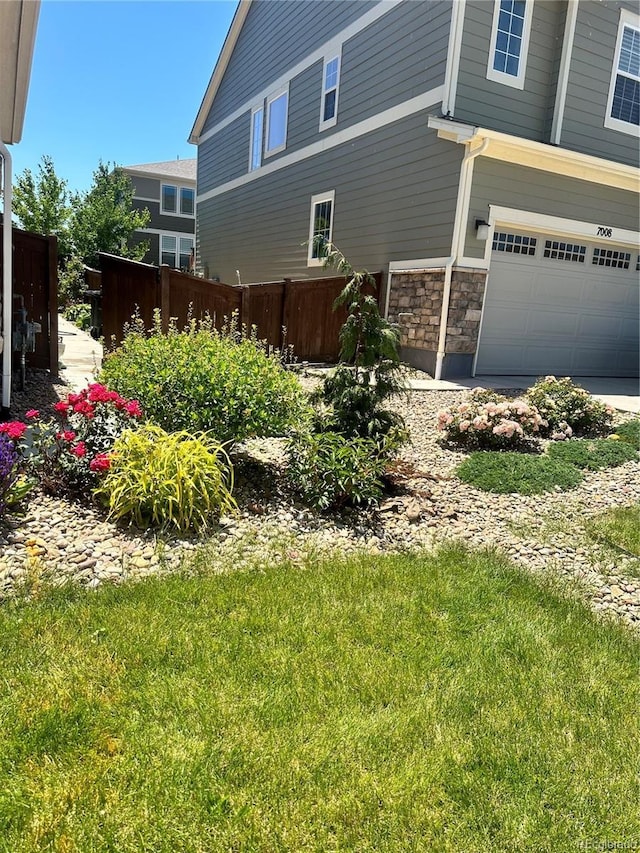 7018 E 123rd Pl, Thornton, CO 80602 - view of side of property with an attached garage and stone siding