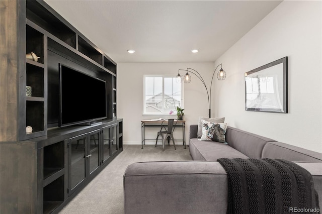carpeted living area featuring baseboards and recessed lighting