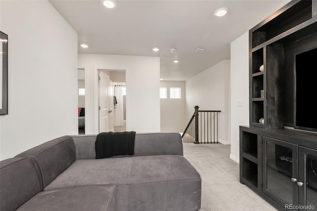 carpeted living room featuring baseboards and recessed lighting