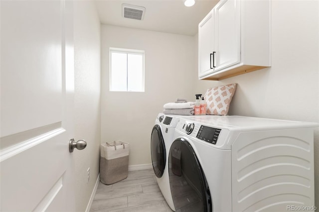 laundry room with independent washer and dryer, visible vents, cabinet space, and baseboards
