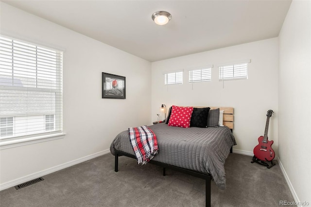 carpeted bedroom with baseboards and visible vents