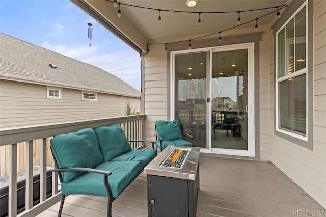 wooden deck with an outdoor living space with a fire pit