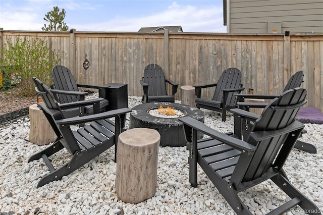 view of patio featuring a fenced backyard and a fire pit