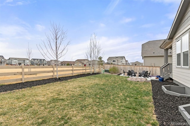 view of yard with a fenced backyard, a residential view, and a patio