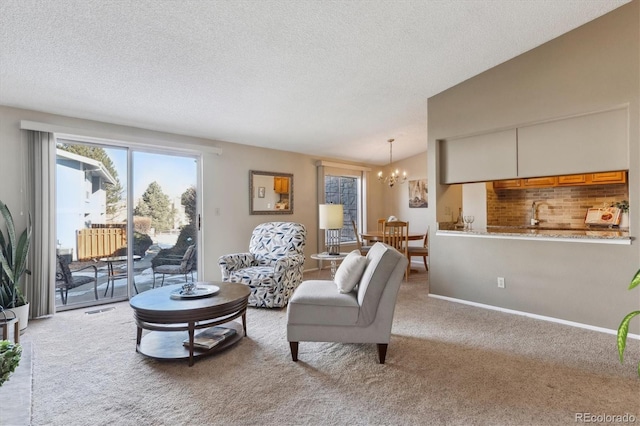 carpeted living room with vaulted ceiling, a notable chandelier, and a textured ceiling