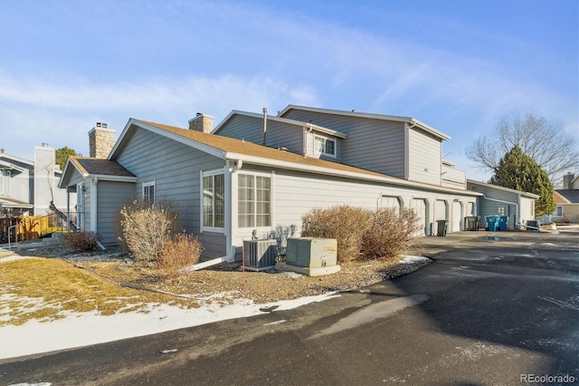 view of home's exterior featuring central AC unit and a garage