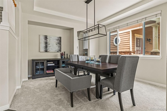 carpeted dining room with baseboards