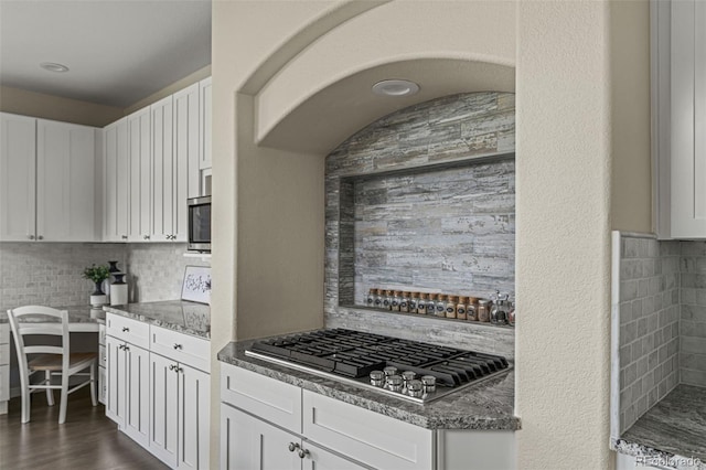kitchen featuring white cabinetry, backsplash, and stainless steel appliances