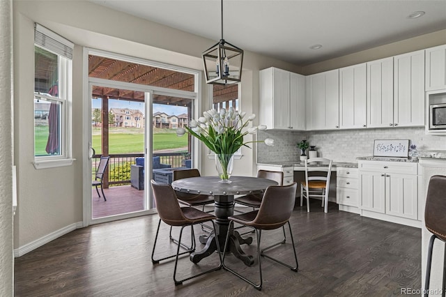 dining area with recessed lighting, baseboards, and dark wood-style flooring