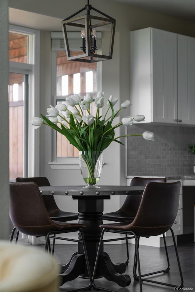 dining area featuring a chandelier and wood finished floors