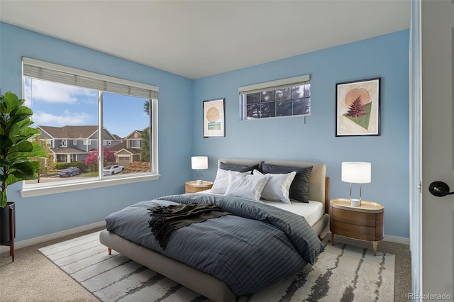 carpeted bedroom featuring baseboards