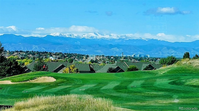 view of property's community with a mountain view and view of golf course