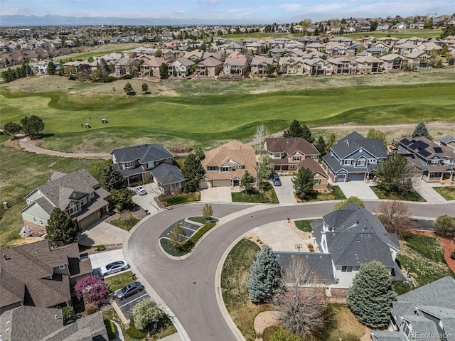 birds eye view of property with golf course view and a residential view