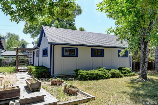 6788 Pierce Way, Arvada, CO 80003 - view of side of home featuring roof with shingles, a garden, and board and batten siding