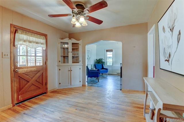6788 Pierce Way, Arvada, CO 80003 - entryway featuring arched walkways, light wood-type flooring, and ceiling fan