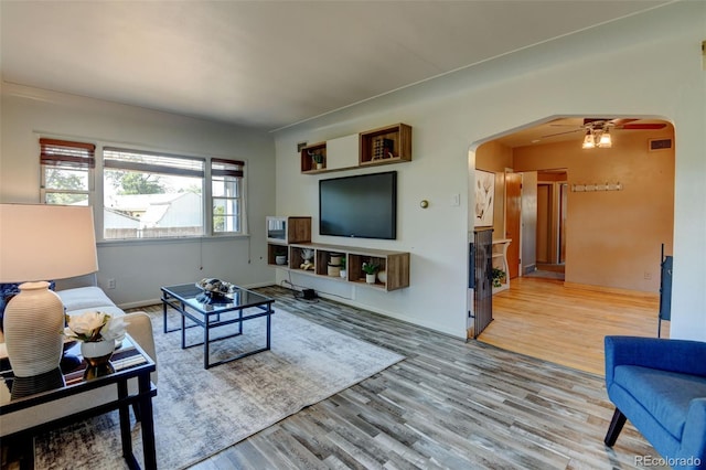 6788 Pierce Way, Arvada, CO 80003 - living room featuring wood finished floors, arched walkways, and ceiling fan